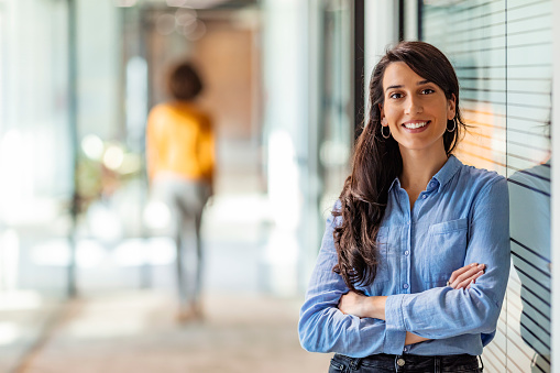 Young mixed race businesswoman smiling to camera