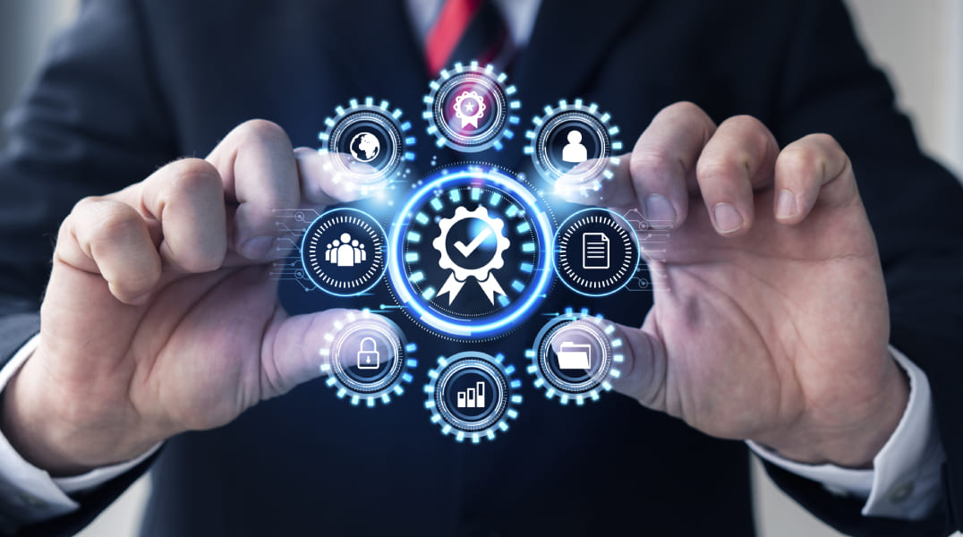 Hands frame a glowing circular hub of quality, security and management icons in a digital interface.